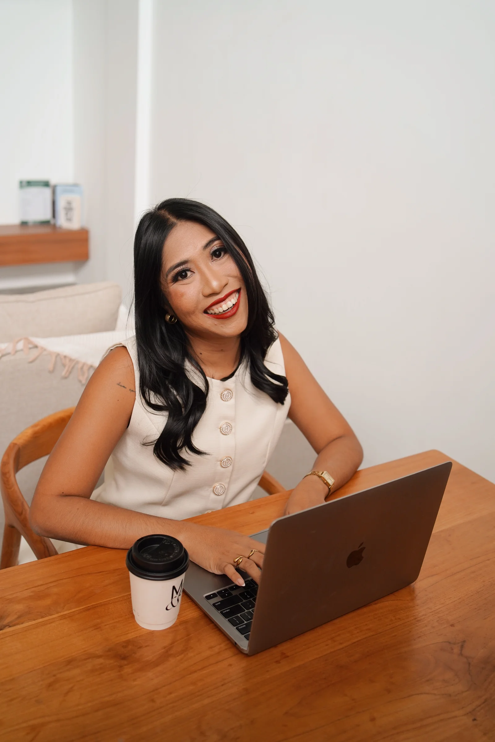 Ellen Velasco smiling at her laptop